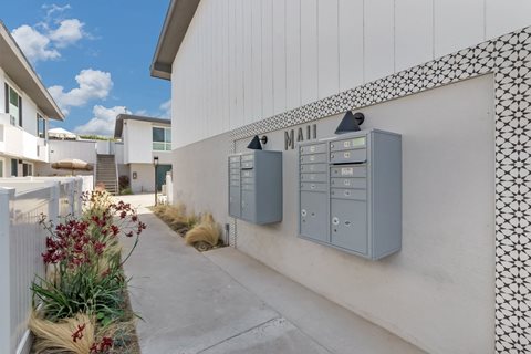 a building with a mailbox and mailboxes on the side of it